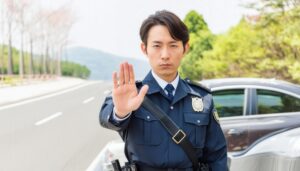 手を挙げて交通を止める警察官