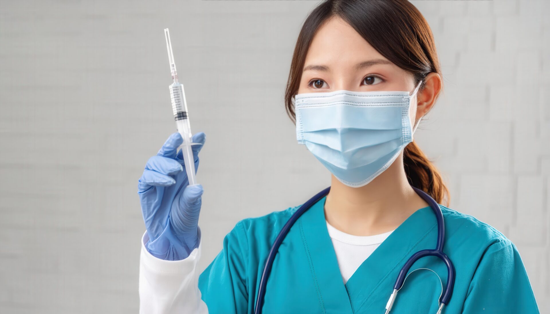 注射器を持つマスク着用の女性看護師