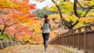 紅葉の遊歩道をランニングする女性
