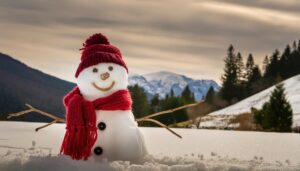 雪山を背景にした赤いマフラーの雪だるま