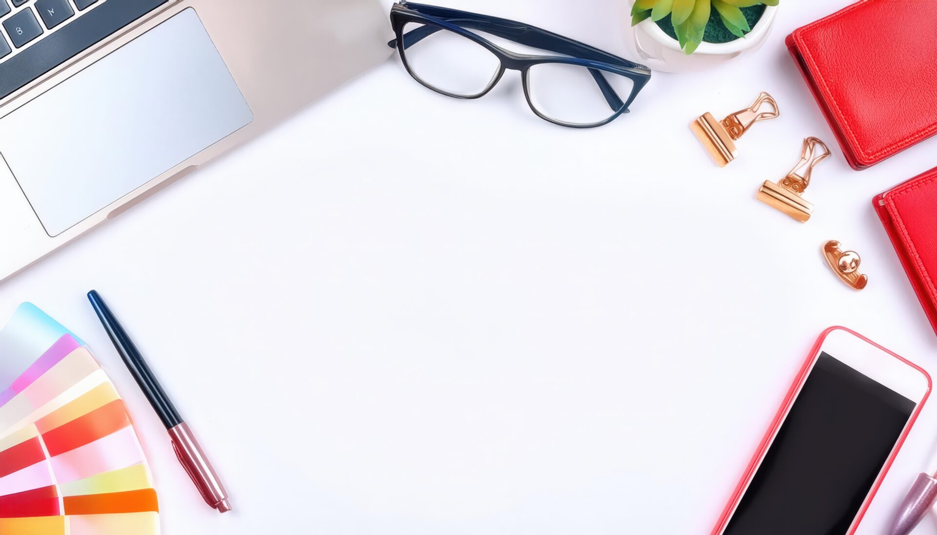 文房具とデバイスが並ぶ白い背景のフラットレイ