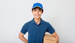 配達用の箱を持つ笑顔の若い男性配達員