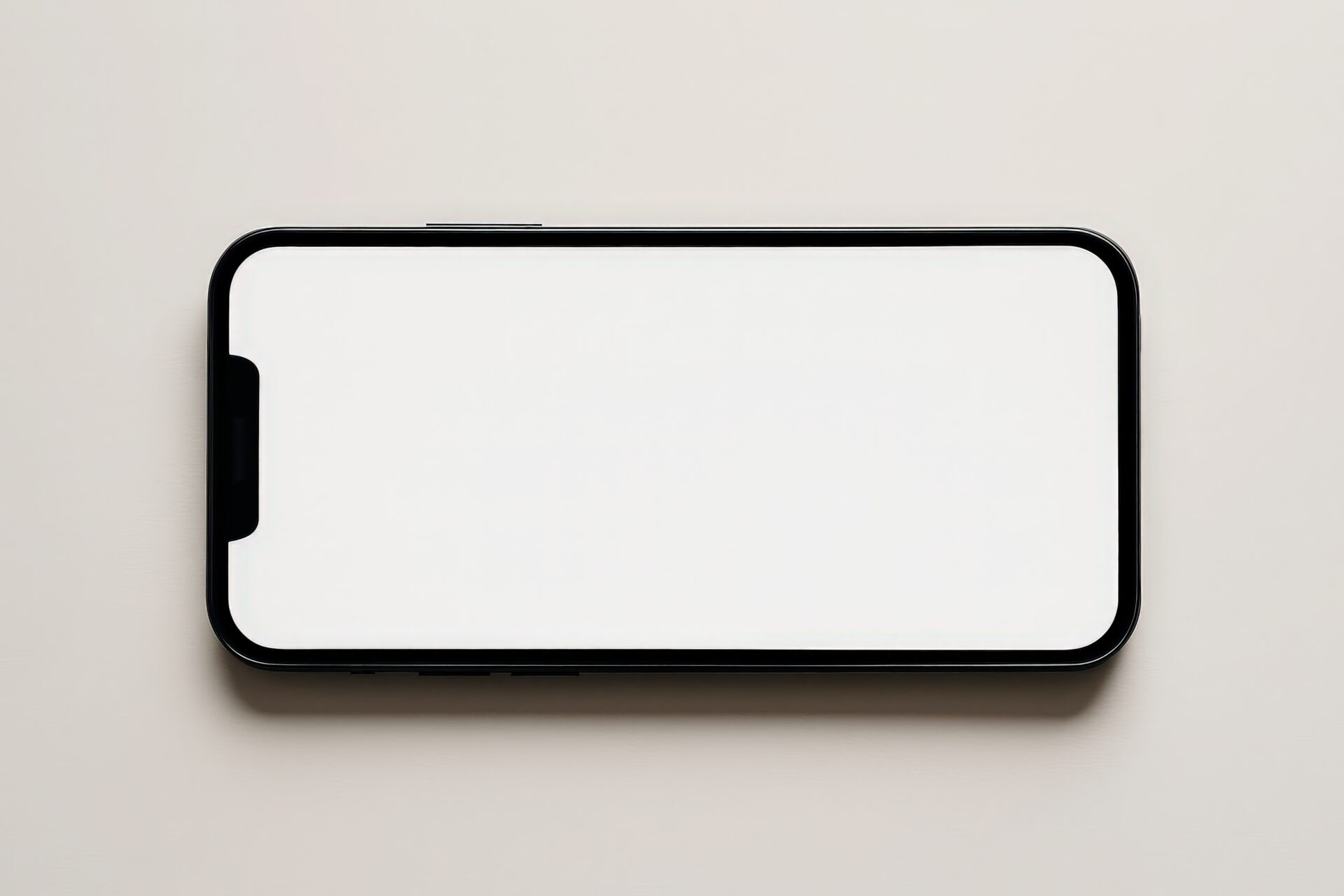 横向きに置かれたスマートフォン（白画面）