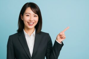 水色背景で指をさして案内するスーツ姿の女性