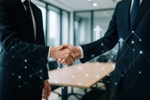 グラフと握手が重なるビジネスシーン
