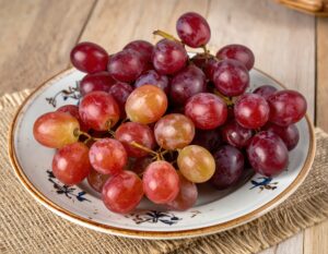 模様付きの皿に盛られた赤いブドウ