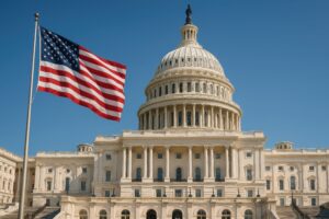 快晴の下に広がるアメリカ議事堂と国旗