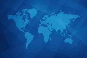 ブルーの幾何学模様に描かれた世界地図の背景