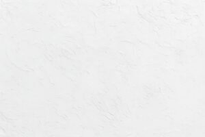 ラフな質感の白壁背景素材