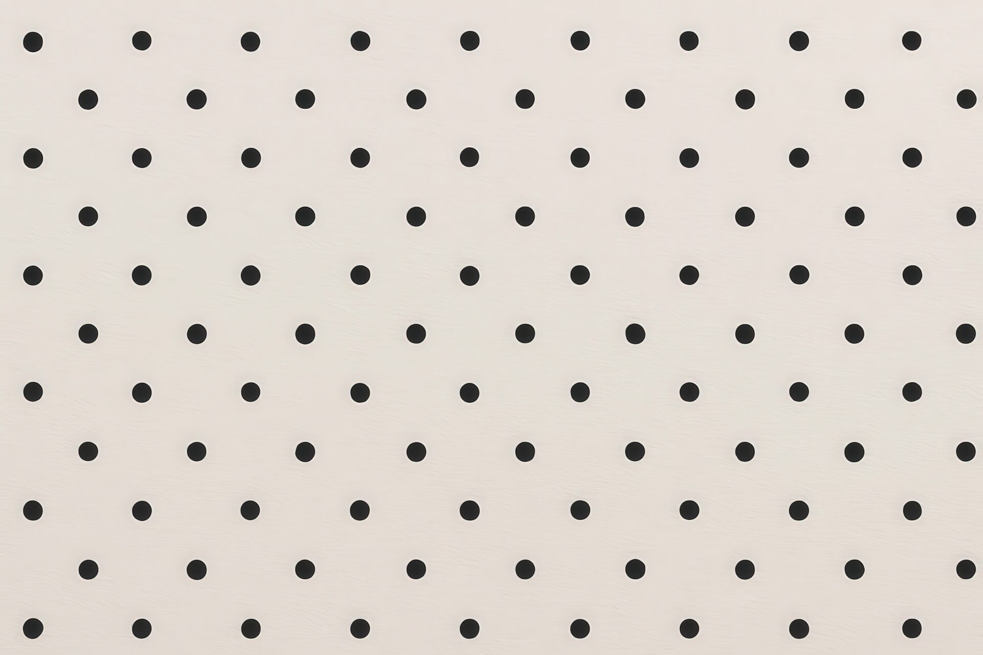 均等に配置された黒ドットのベージュ背景