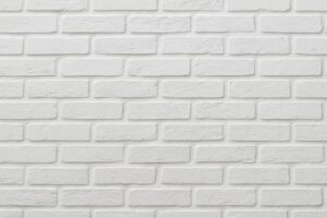 明るい白レンガが整然と積まれた壁のテクスチャ
