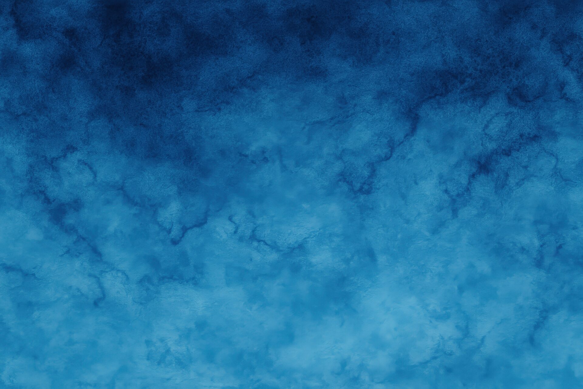 青の濃淡が広がる抽象的な質感背景
