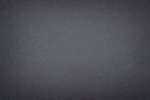 ノイズ風のピクセルが広がる暗いデジタル背景