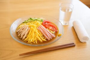 夏のテーブルに置かれた彩り豊かな冷やし中華