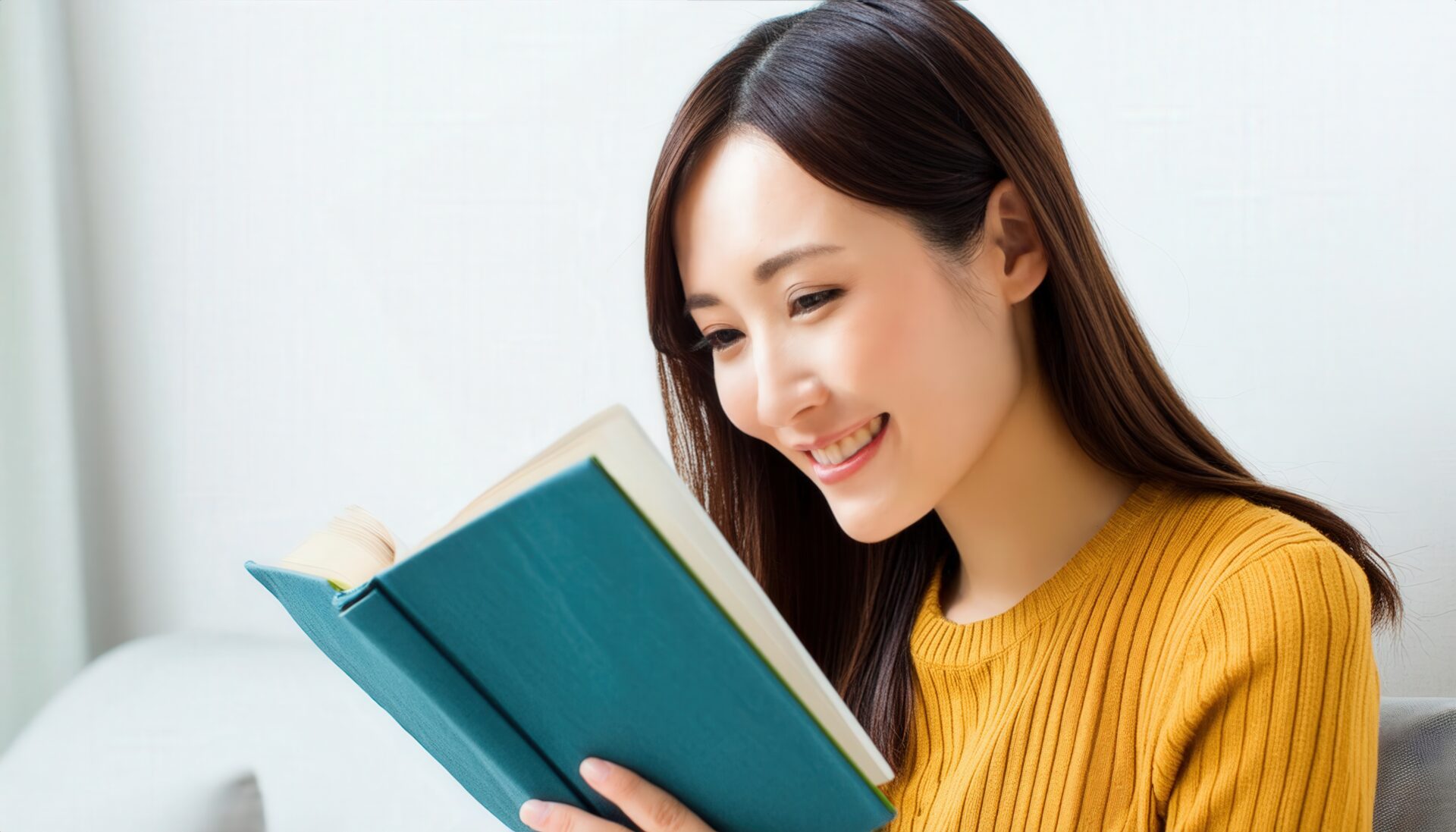 本を読む女性（黄色のニット）