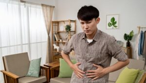 部屋で悩む男性