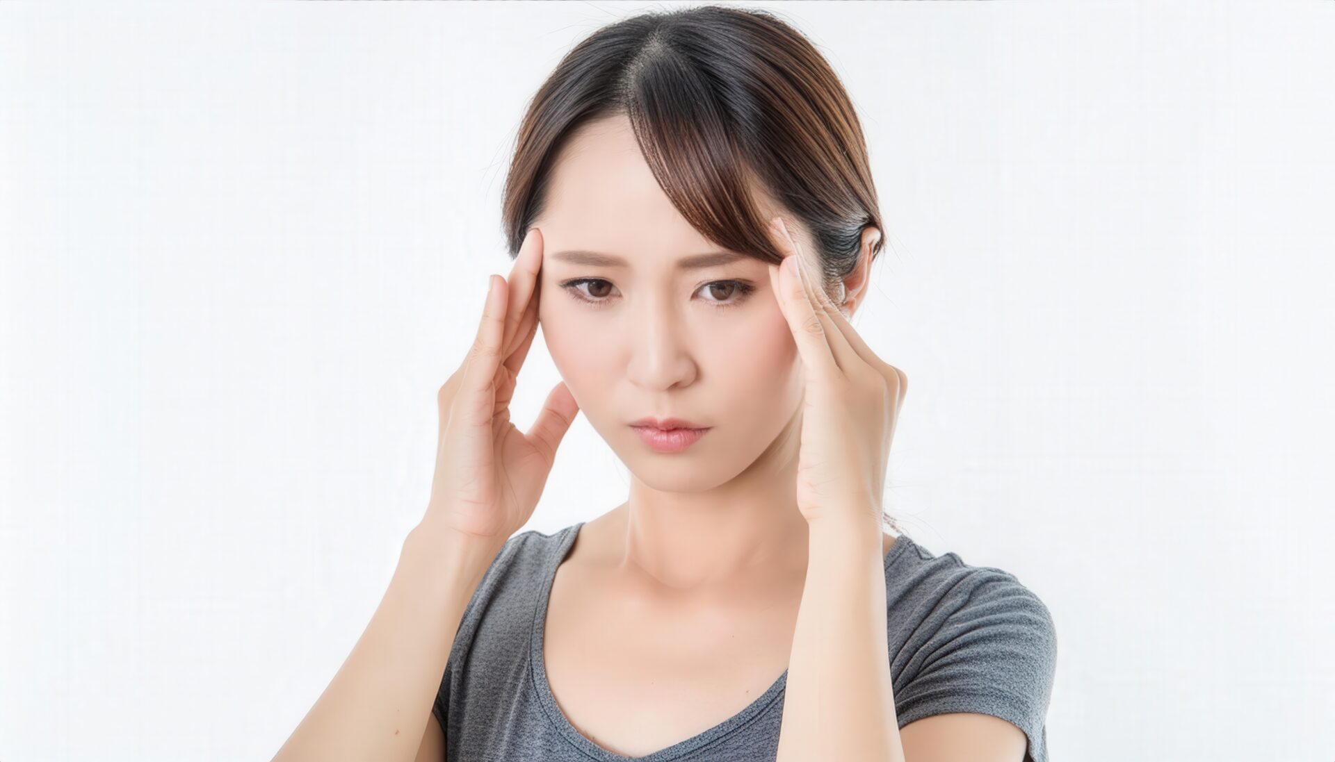 両手で頭を抑える女性