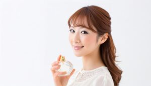 白いレース服の女性が丸い香水を手に笑顔