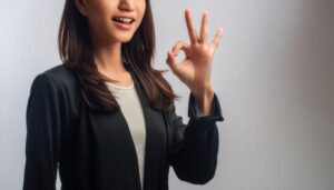 グレー背景でOKサインをする人物