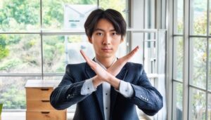 スーツ姿で腕をクロスしている若い人