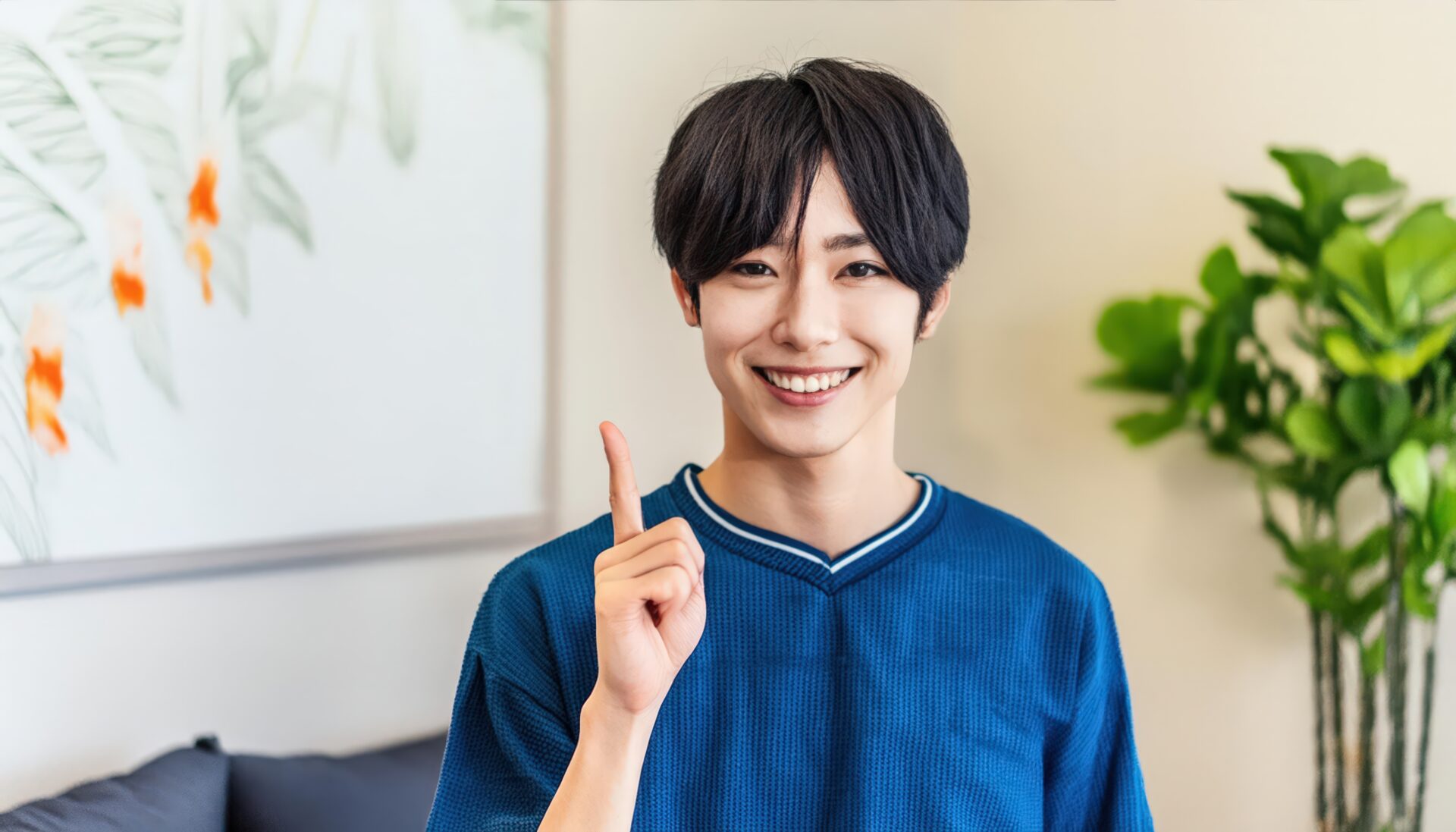 ブルーのトップスを着た若い人が指をさす