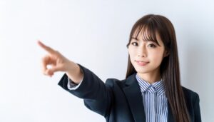 ストライプのシャツを着たスーツ姿の若い人が指をさす