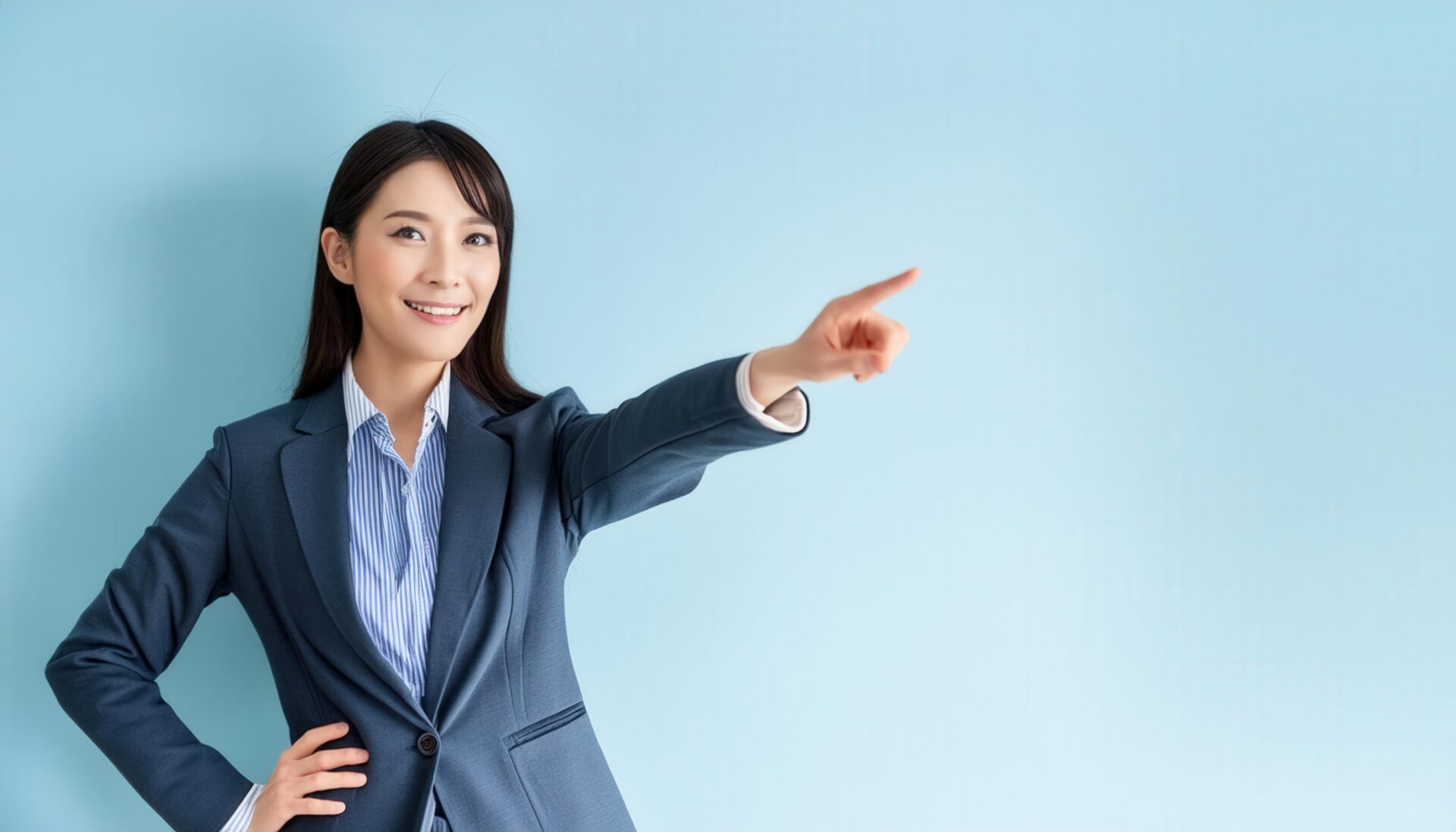 水色の背景でスーツ姿の若い人が指をさす