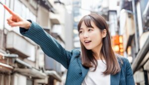 街中でストライプジャケットを着た若い人が指をさす