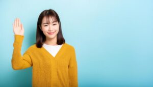 マスタード色のセーターで手を上げる人