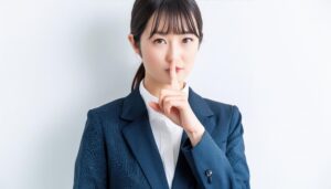 ポニーテールで口止めの仕草をする人