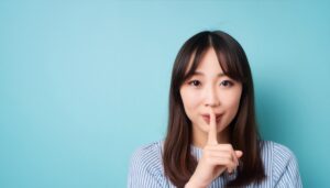 静かにするジェスチャーを示す人物