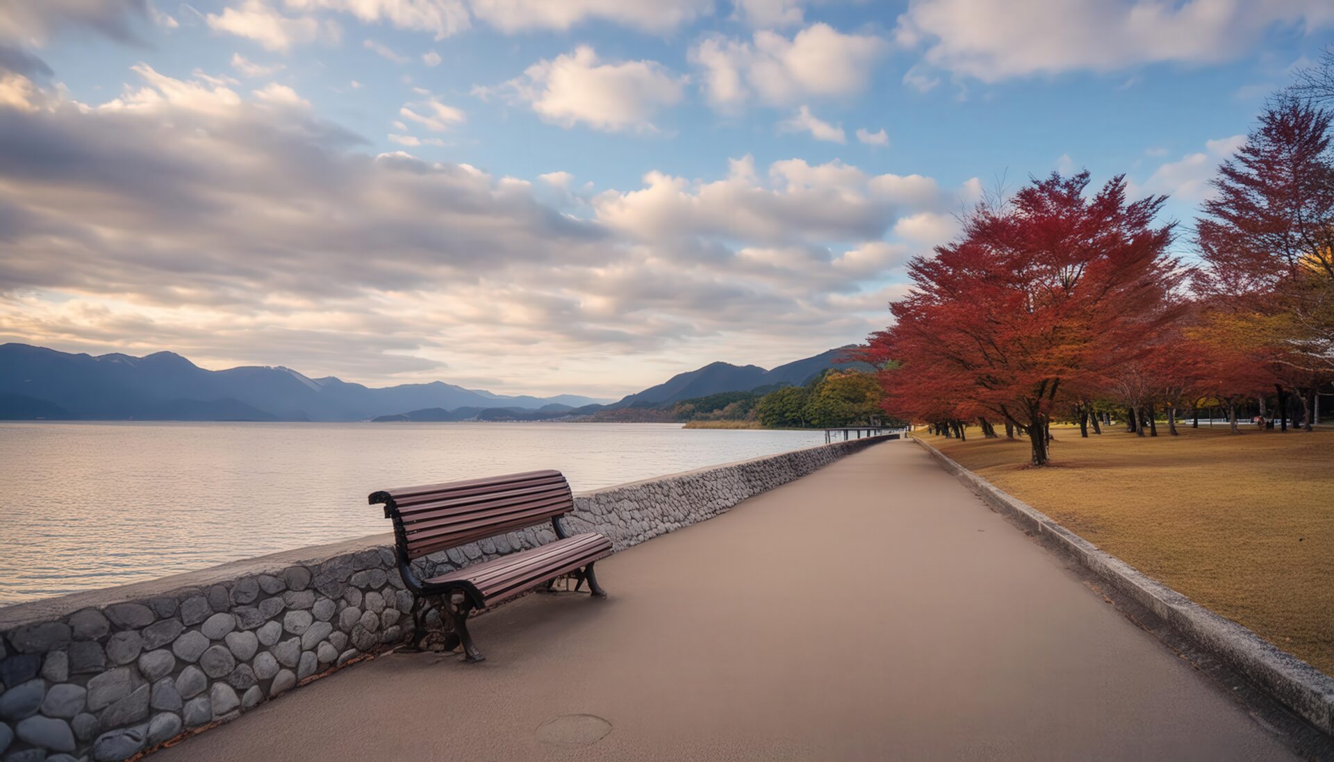 湖畔のベンチと紅葉の木々