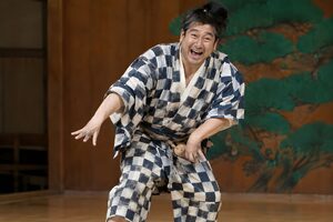 狂言の演者が舞台でおどけた仕草をする場面