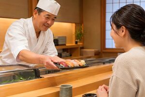 お客に寿司を差し出す職人