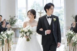 チャペルでバージンロードを歩く新郎新婦