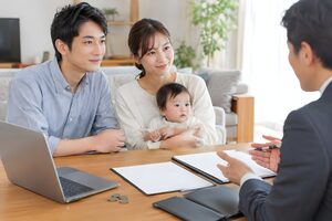 赤ちゃんを抱いて保険の相談をする30代夫婦