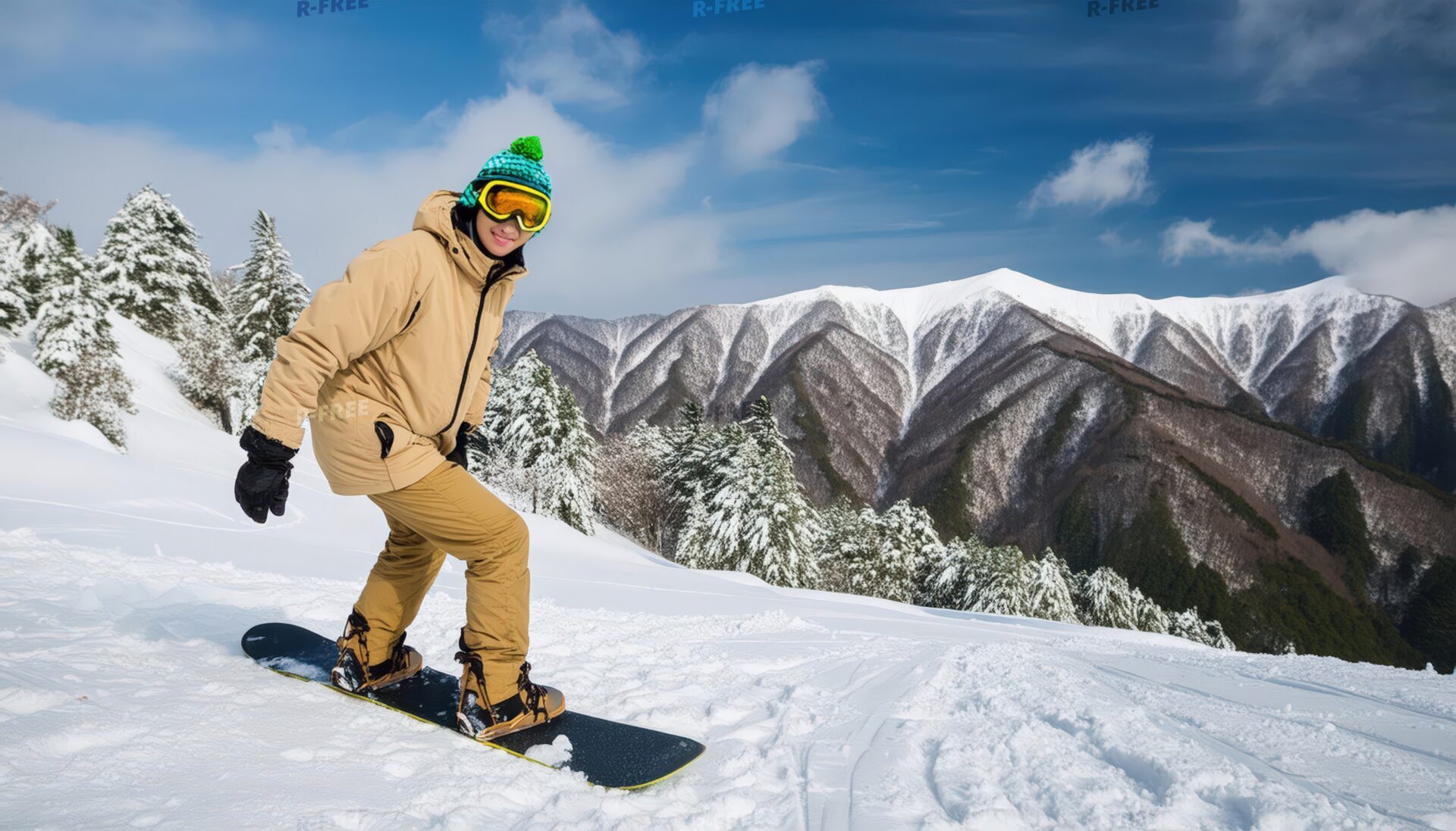 雪山でスノーボードを楽しむ男性