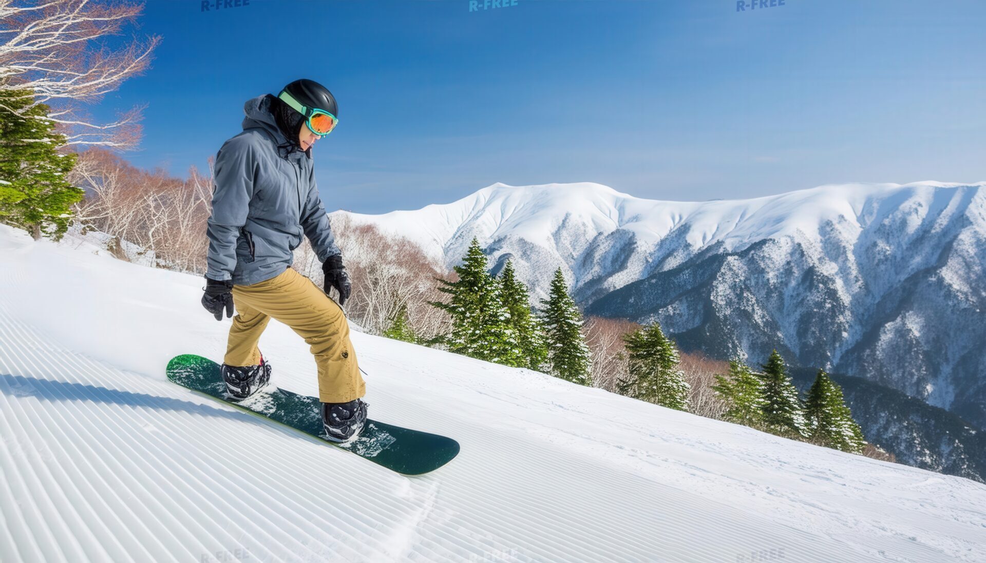 雪山を滑降するスノーボーダー