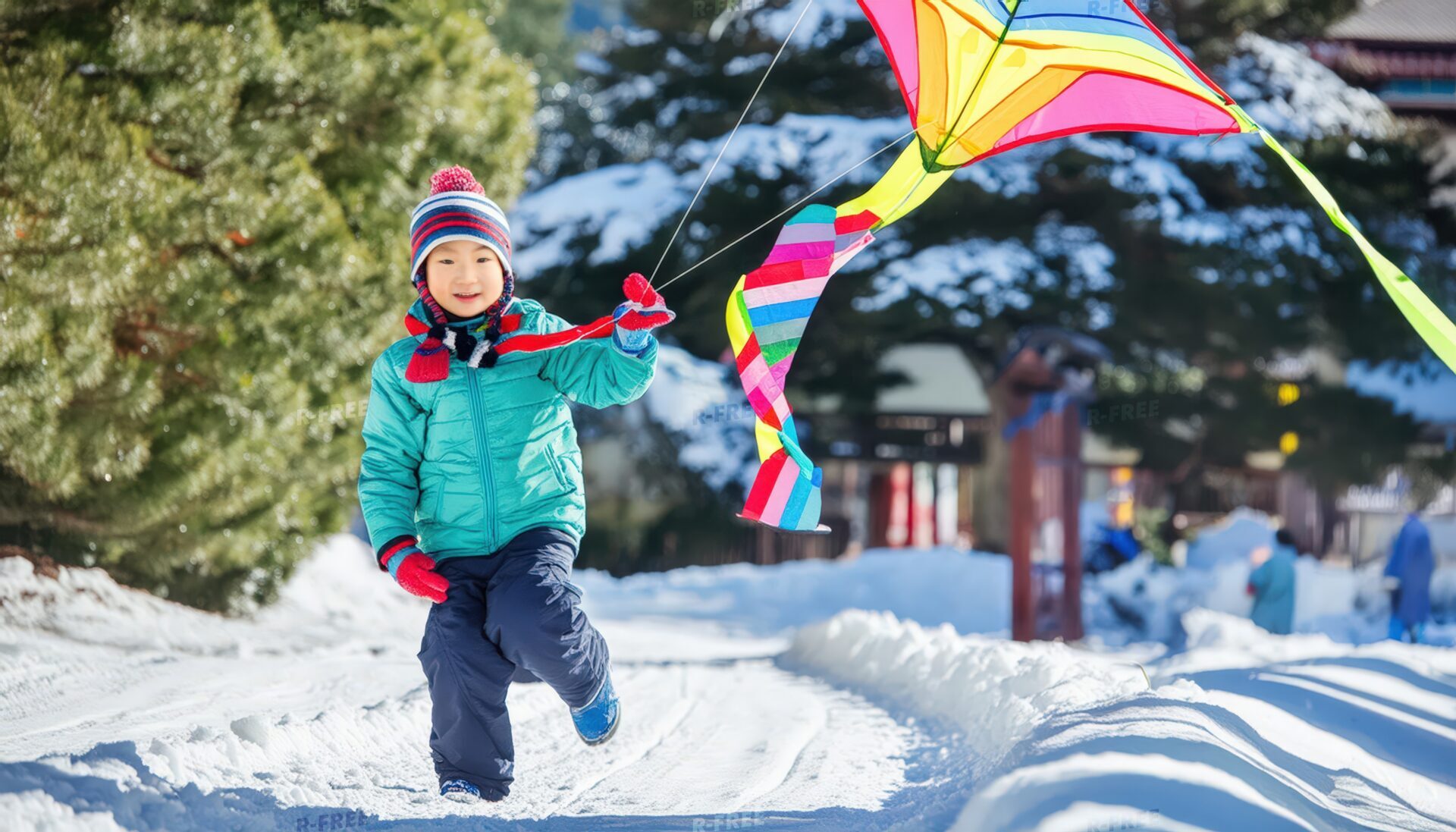 雪の中で凧を揚げる子供