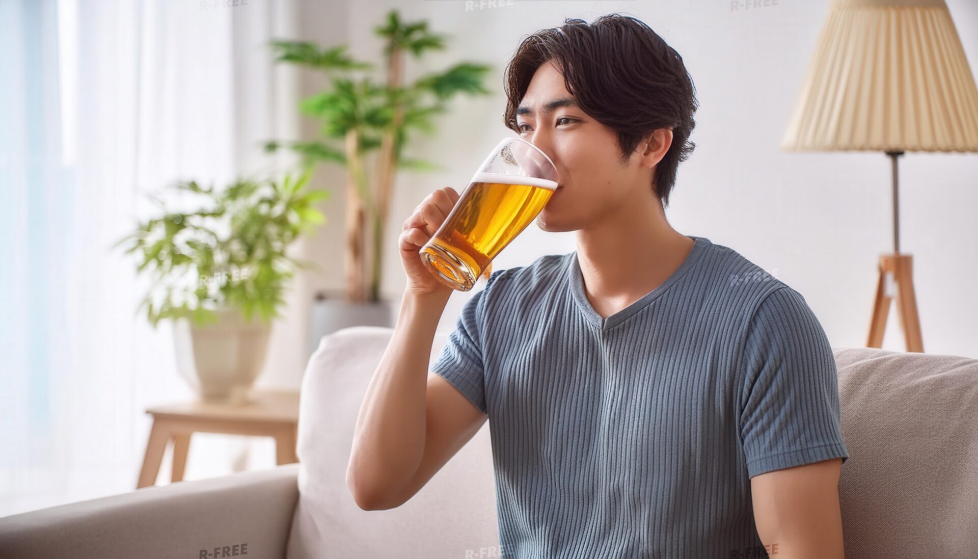 室内でビールジョッキを飲む若い男性