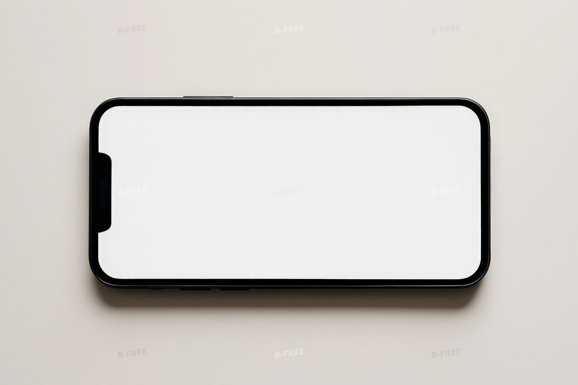横向きに置かれたスマートフォン（白画面）