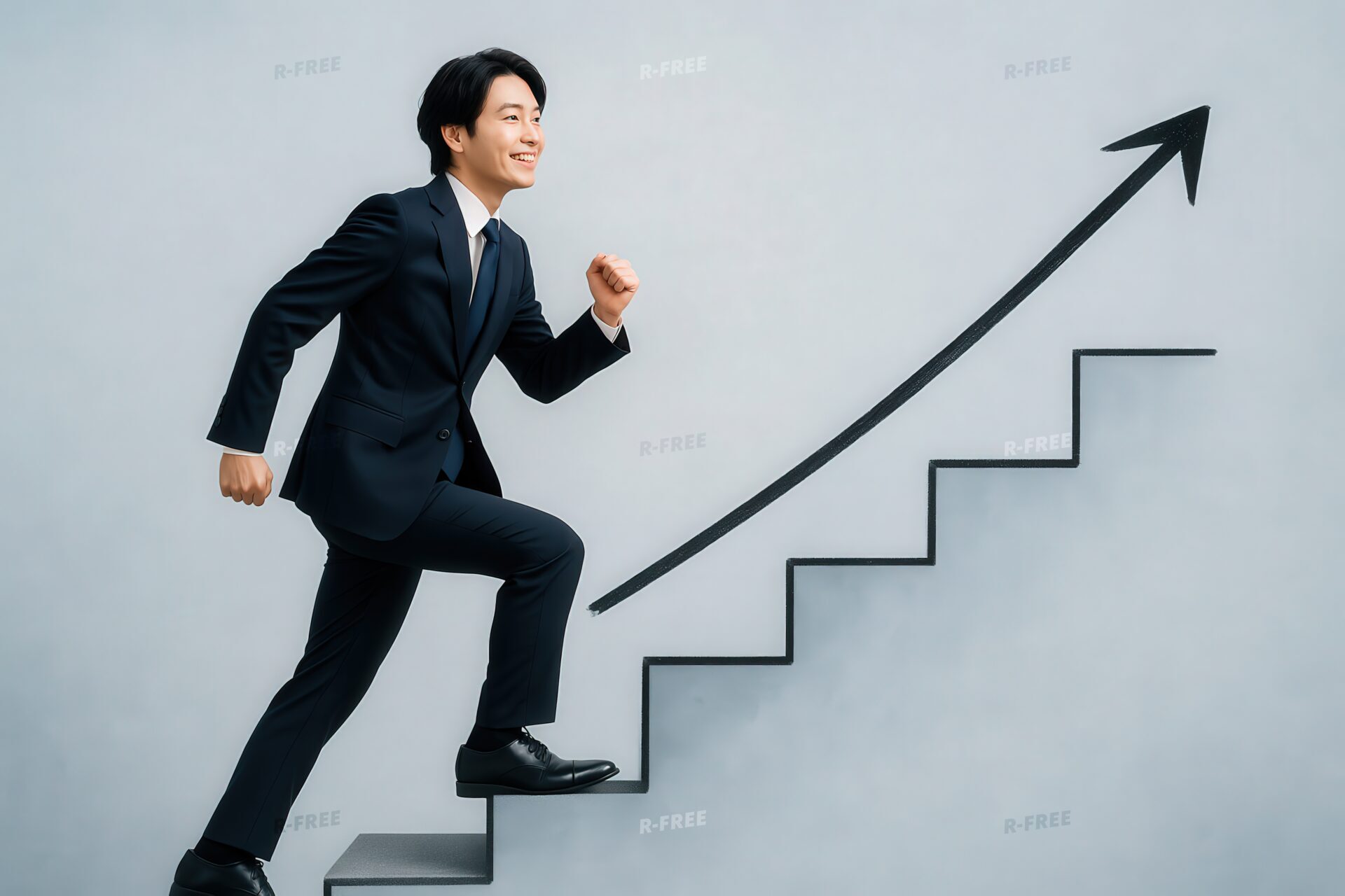 成長を目指して階段を上るスーツ姿のビジネスマン