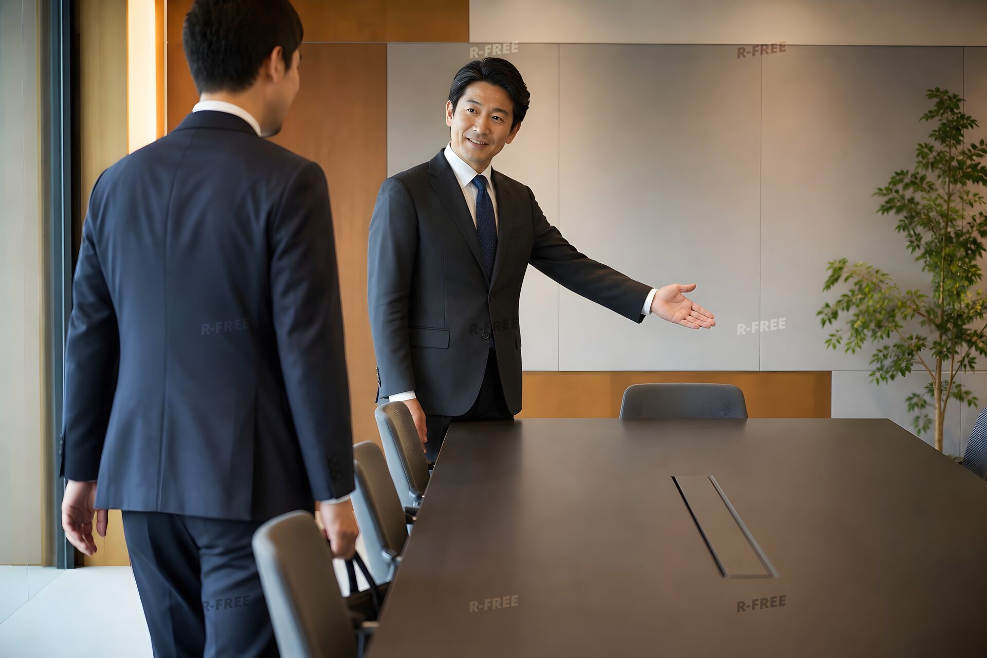 来客を上座へ案内する40代男性