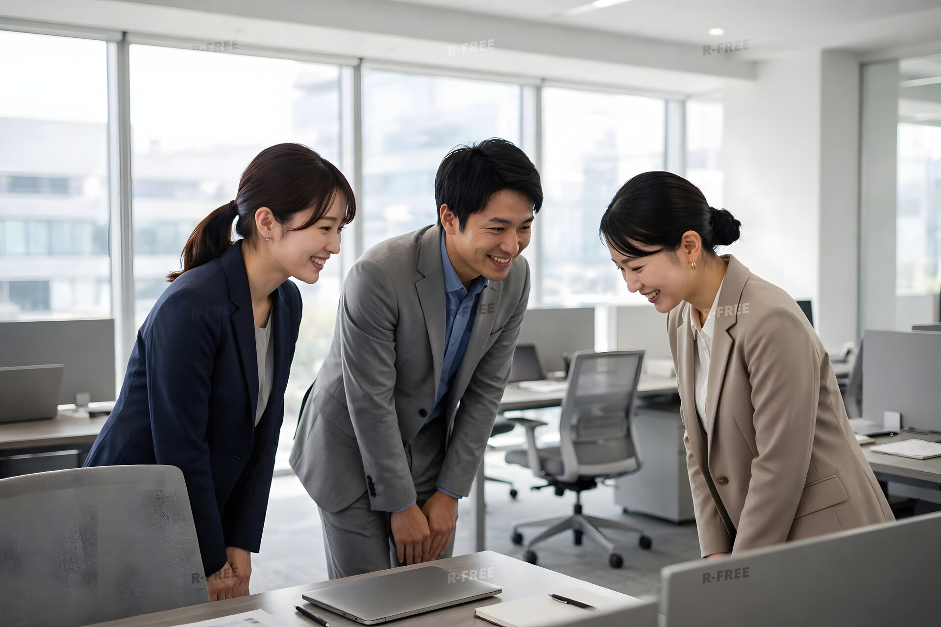 出社して挨拶を交わす3人の社員
